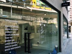 a store front with glass windows on the side of it and graffiti written on the window