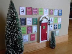 a red door is in front of a wall with christmas trees and decorations on it