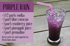 a purple drink is sitting on a wooden table with the words purple rain written below it