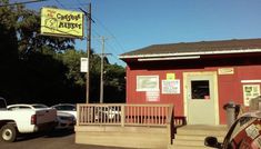 there is a small red building with a sign that says the coffee parlor on it