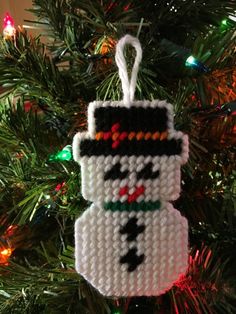 a knitted ornament hanging from a christmas tree