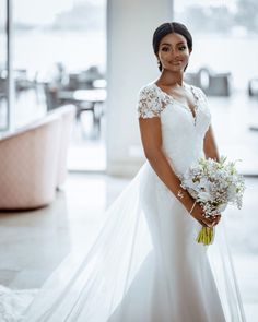 a woman in a wedding dress holding a bouquet