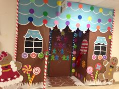 an indoor gingerbread house decorated with candy canes and candies for the door