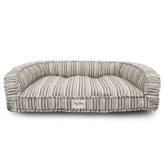 a dog bed that is striped in grey and white