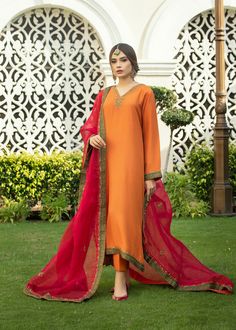 Burnt orange Rawsilk kaftan kurta with handwork on neckline & embalishments on slevees and front & back ghaira chak with tilla, zardozi & dabka. Paried with a bright Fuscia colored embossed organza duppata with emerald green borders & similar work on 4 sides. Festive Naqshi Chanderi Kurta, Festive Chanderi Kurta With Naqshi Detail, Wedding Chanderi Kaftan With Mirror Work, Festive Anarkali Kaftan With Mirror Work, Designer Semi-stitched Kaftan With Mirror Work, Transitional Silk Kurta With Dabka Detailing, Anarkali Raw Silk Kaftan With Resham Embroidery, Traditional Designer Kaftan With Mirror Work, Festive Chanderi Kaftan With Mirror Work