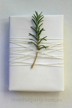 a wrapped gift with a sprig of rosemary on it is shown in an instagram