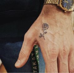 a person with a rose tattoo on their hand