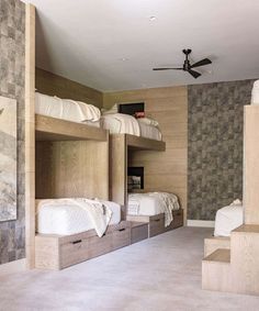 a room with bunk beds and drawers in it