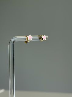 Brighten up your jewelry collection with our charming Pink Enamel Star Stud Earrings. Crafted from 14k solid gold, these delicate studs feature a whimsical star design adorned with soft pink enamel, adding a playful yet elegant touch to any outfit. Perfect for daily wear or special occasions, these earrings are both versatile and stylish. The secure push-back closure ensures a comfortable fit, so you can wear them confidently all day or night. P R O D U C T ∙ M E A S U R E M E N T S * 100% 14k Solid Gold * Diameter: 6mm/ 0.25 inch * Width: 1mm/ 0.04 inch * Weight: 0.45g Delivery:  * Ready to ship in 1 business day. * Delivers in 1 to 5 days depending on location and delivery option. * Returns are accepted within 7 days from the delivery date, at the customers cost. Gift Option: * We cheris Cute Gold Star Jewelry, Enamel Star Charm Jewelry, Tiny Star-shaped Earrings For A Gift, Tiny Star-shaped Earrings For Gifts, Tiny Star-shaped Earrings As A Gift, Rose Gold Earrings With Star Charm As A Gift, Rose Gold Star Earrings For Gift, Pink Star Charm Jewelry For Gift, Gold Star Earrings