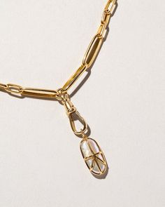 Swivel fob charm with spring hinged clasp, set in 14k yellow gold.