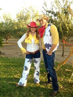 a man and woman dressed up in cowboy outfits standing next to each other on the grass