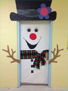 a door decorated to look like a snowman wearing a top hat and scarf with antlers