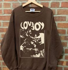 a brown sweatshirt with the words lovejoy printed on it