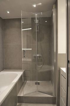 a bathroom with a walk in shower next to a bathtub