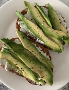 two pieces of bread with avocado on them