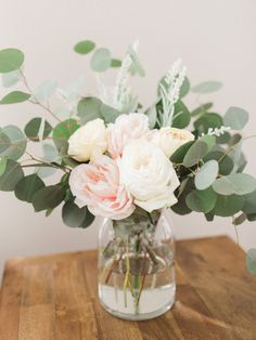 an instagram page with flowers and greenery in a vase on a wooden table