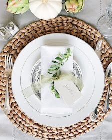 a place setting with white plates and napkins