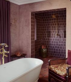 a bath room with a tub and a chair