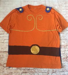 an orange t - shirt with a gold coin on it