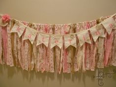 a pink and white banner hanging on the wall