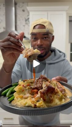 a man is eating food from a plate