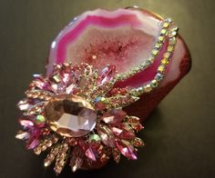 OOAK Wearable Art Cuff. A hot pink, freeform, druzy agate hosts gorgeous freeform pink agate jewel and two rows of aurora borealis rhinestones. Embellishments measure 4.5" x 3.5". The cuff is a faux pink snake print. Cuff has a gold metal interior and edge. Cuff is 4" at the widest point and tapers to narrower curve on your inner forearm. Will best fit wrists up to 7". Pink Crystal Brooch Jewelry, Pink Crystal Jewelry Brooch, Pink Gemstone Jewelry For Evening, Party Crystal Brooch Jewelry, Handmade Pink Jewelry For Evening, Handmade Pink Evening Jewelry, Dazzling Pink Jewelry For Party, Unique Pink Jewelry With Stones, Pink Crystal Jewelry For Evening