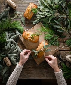 orange ginger honey cakes on a cutting board surrounded by greenery and twine sprigs