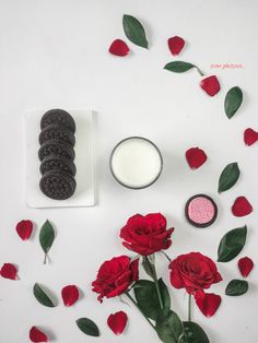 red roses and oreo cookies on a white surface