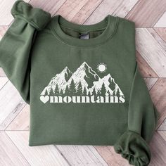 This Mountain Themed Sweatshirt is a perfect gift for all nature lovers who love the outdoors.  Also this Mountains Sweatshirt makes a perfect family vacation shirt.  Whether it's a gift for mom or dad, trail runners, cross country or hikers, they are sure to love it!   SUPER SOFT AND COZY CREWNECK SWEATSHIRTS AND HOODIES S H I R T / D E T A I L S Our sweatshirts are SUPER soft and SUPER comfy. For Women They Run Oversized! 50% Cotton/50% polyester and pre-shrunk.  We Use Soft and Cozy Gildan 18 Spring Outfits Mountains, Mountain Sweatshirt Design, Cotton Sweatshirt For Outdoor Fall Activities, Hoodie Top For Outdoor Fall Activities, Fall Hoodie Top For Outdoor, Fall Outdoor Hoodie Tops, Hoodie Top For Outdoor Fall Events, Cozy Sweater For Outdoor Activities In Fall, Hoodie Tops For Fall Outdoor