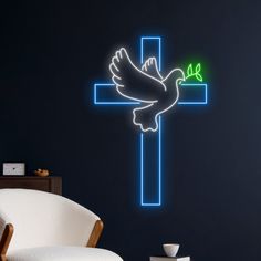 a cross with a dove and a green leaf on it is lit up in the dark