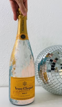 a bottle of champagne being held by a person