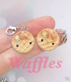 a hand is holding two miniature waffles