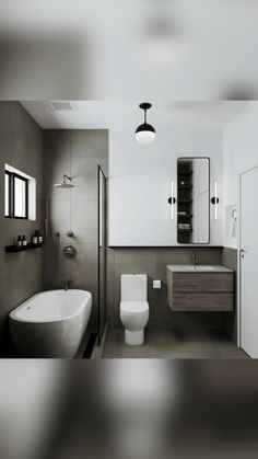 a white toilet sitting next to a bath tub under a bathroom mirror above a sink