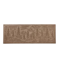 a beige door mat with trees and the moon in the sky on it's side