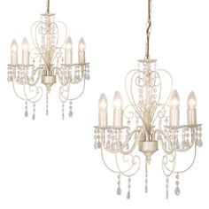 two white chandeliers with crystal drops hanging from them