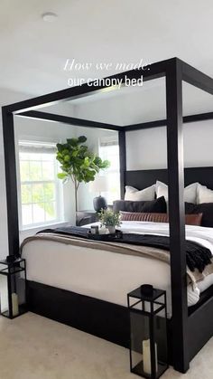 a bedroom with a four poster bed and white walls