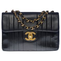 Majestic Chanel Jumbo single flap bag in black quilted lambskin leather with vertical stitching, gold-plated metal hardware, gold-plated metal chain handle interlaced with black leather for shoulder support Flap closure, gold CC logo clasp Bordeaux leather interior, 1 patch pocket, 1 zipped pocket Signature: "Chanel Paris®Made in France” Date: 1994 / 1996 Dimensions: 30 x 22 x 8 (12 x 9 x 3 Inches) Chain length: 65 cm (25,5 Inches) Reference: 100515 Packaging: Hologram: Yes (damaged) Authenticit Chanel Jumbo, Shoulder Support, Chanel Paris, Black Quilt, Cc Logo, Vintage Chanel, Metal Hardware, Flap Bag, Lambskin Leather