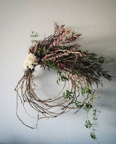 dried flowers and greenery hang on the wall