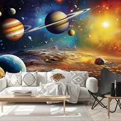 a living room filled with furniture and wallpaper covered in space themed murals, including the solar system