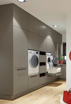 a modern laundry room with washers and dryers in the wall, along with other appliances