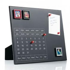 a desk calendar with magnets and pictures on it