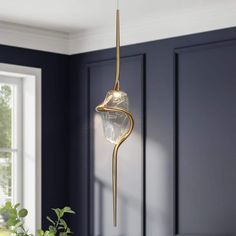 a light fixture hanging from the ceiling in a room with dark blue walls and white trim