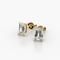 14K Yellow Gold Emerald Cut Diamond Stud Earrings (Mounting). This pair of classic, emerald shape diamond earrings feature a tapered basket that showcases the unique characteristics of the emerald shape diamonds of your choice. The bold flashes of light and a luminescent nature capture the eye with every move. Emerald Cut Diamond Earrings, Emerald Cut Stud Earrings, Jewelry Photoshoot, Emerald Cut Diamond, Unique Characteristics, Funky Jewelry, Diamond Stud Earrings, Fine Jewelry Designers, Pear Shaped Diamond