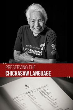 an older woman sitting at a table with a book in front of her and the title, preserving the chickasan language