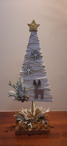 a christmas tree made out of paper on top of a wooden table