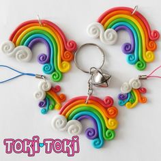 a keychain made to look like a rainbow with swirls and clouds on it