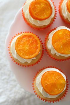 cupcakes with frosting and orange slices on a plate