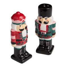 two ceramic nutcrackers are standing next to each other on a white background