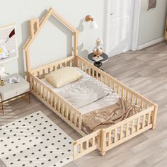 a small wooden bed sitting on top of a hard wood floor next to a white rug