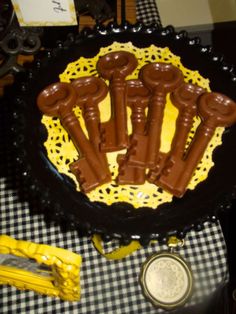 chocolate candies are arranged in the shape of bones on a black and white checkered tablecloth